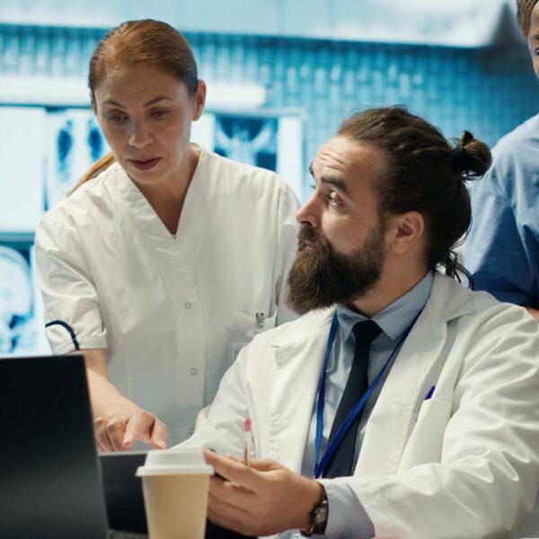 Doctors and nurses working in a healthcare facility to develop treatment protocols. Medical staff engaged in a discussion about healing strategy in a private clinic, healthcare industry. Camera A.